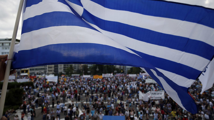 A protester waves a Greek flag during an anti-austerity pro-government rally in front of the parliament building in Athens, Greece, June 21, 2015. (Reuters / Yannis Behrakis)