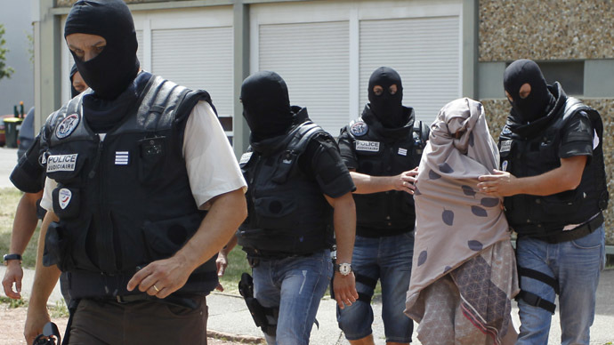 French special Police forces escort a woman from a residential building during a raid in Saint-Priest, near Lyon, France, June 26, 2015. (Reuters / Emmanuel Foudrot)