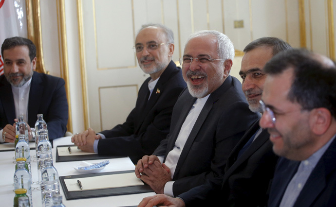 Iranian Foreign Minister Javad Zarif (C) laughs during a meeting with U.S. Secretary of State John Kerry (not pictured) at a hotel in Vienna, Austria June 30, 2015. (Reuters / Carlos Barria)