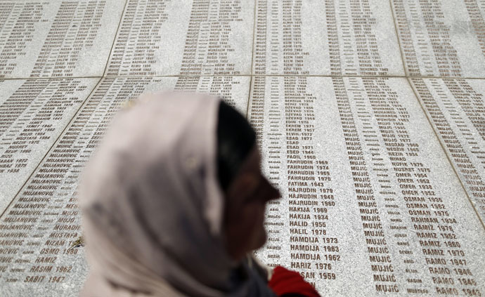 A woman stands in front of the Memorial Center during a reburial ceremony of 136 newly identified victims in Potocari, near Srebrenica, Bosnia and Herzegovina July 11, 2015. (Reuters/Antonio Bronic)
