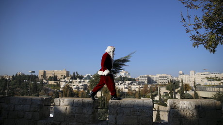 Un homme en costume de Père Noël sur le sur de la vielle ville de Jérusalem