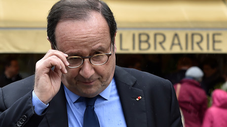 
L'ancien président français François Hollande quitte une librairie de Tulle après une séance de dédicace, le 14 avril 2018