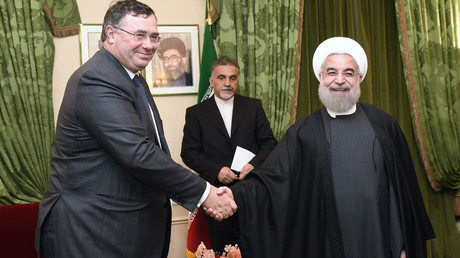 Patrick Pouyanné et le président iranien Hassan Rohani échangent une poignée de main le 28 janvier 2016 lors d’une rencontre à Paris