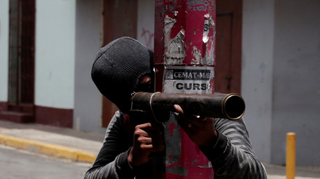 Un manifestant se prépare à tirer avec une arme à feu artisanale sur la police antiémeute lors d'une manifestation contre le gouvernement du président nicaraguayen Daniel Ortega à Monimbo, au Nicaragua, le 12 mai 2018. 