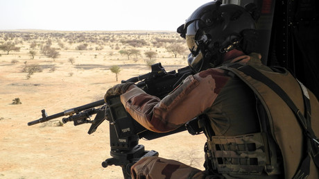 Un soldat français de la mission Barkhane met sa mitraillette en joue  depuis un hélicoptère NH90 entre Gao et Menaka, au Mali, le 21 mars 2019. 