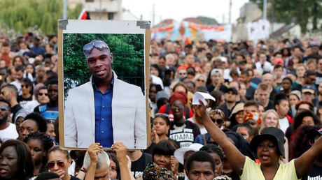 Une personne tient un portrait de feu Adama Traoré lors d'une marche, le 21 juillet 2018 à Beaumont-sur-Oise, au nord-est de Paris (image d'illustration).