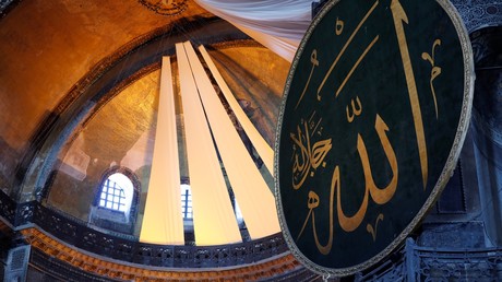 Des rideaux couvrent les fresques chrétiennes de l'ancienne basilique byzantine Sainte-Sophie, reconvertie en mosquée, lors de prières, à Istanbul le 26 juillet 2020.