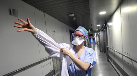 Un médecin des hôpitaux universitaires de Strasbourg enfile une tenue de protection contre le coronavirus, le 13 novembre 2020 (image d'illustration)