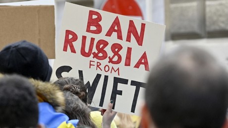 Un manifestant brandit une affiche «Bannir la Russie de SWIFT» lors d'une manifestation contre l'invasion de l'Ukraine par la Russie, le 26 février 2022 devant l'ambassade de Russie à Vienne, en Autriche (image d'illustration).