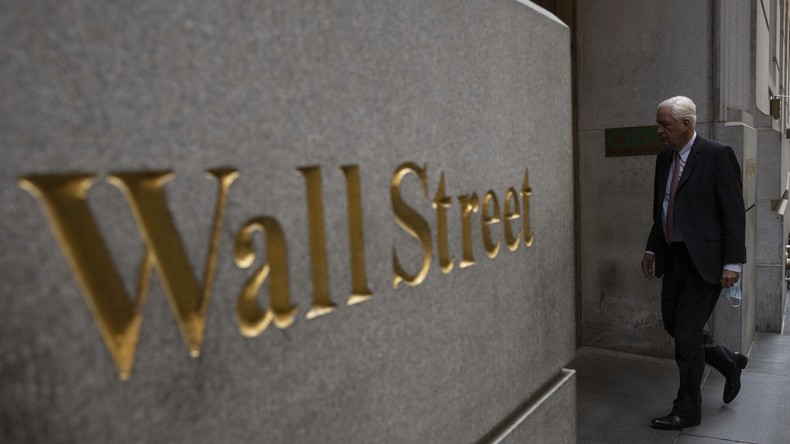 Un homme passe devant un panneau indiquant Wall Street près de la Bourse de New York (image d'illustration).