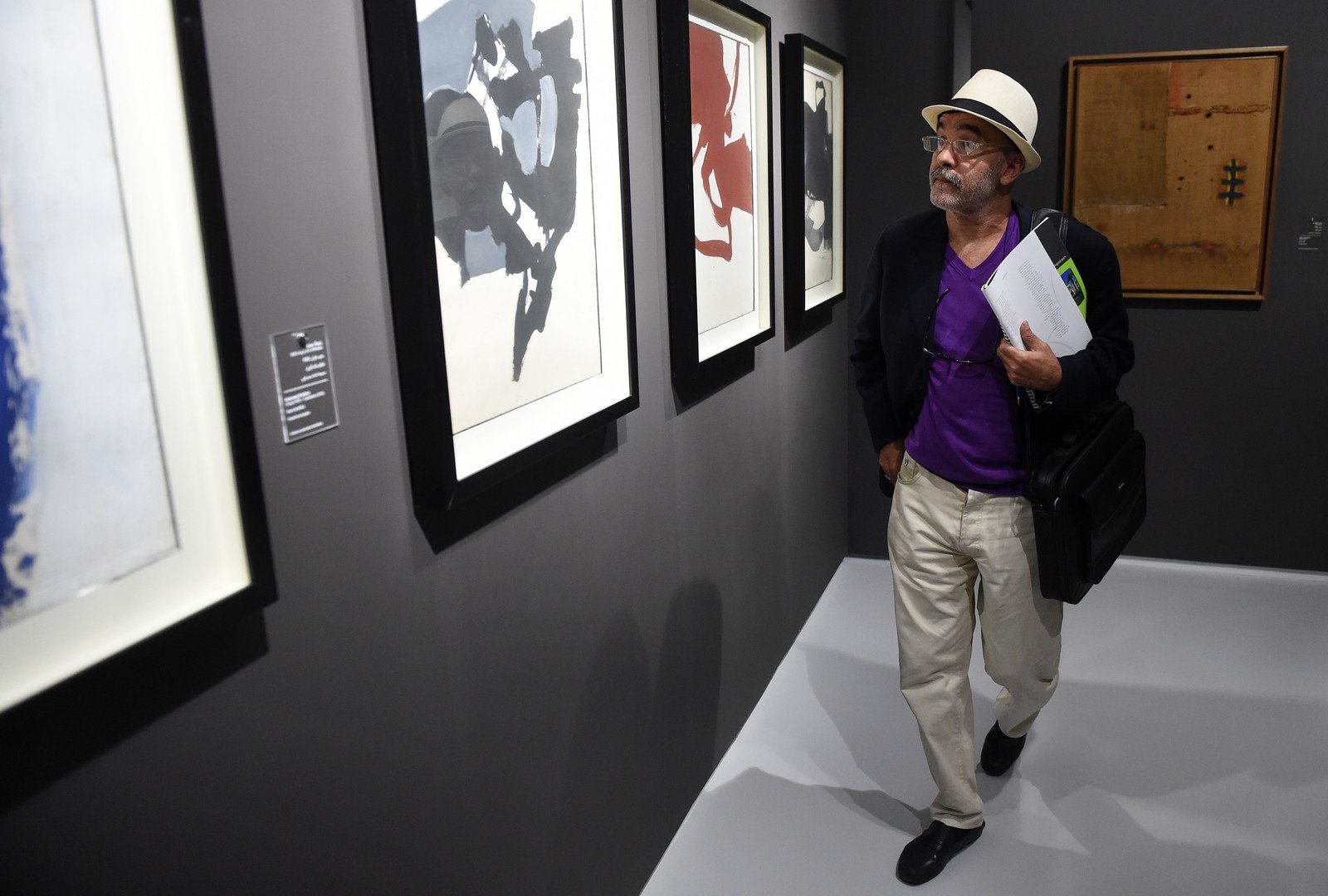 رجل ينظر للوحات محمد شابا