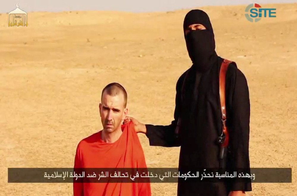 مسلح من داعش أثناء التهديد بقتل البريطاني دافيد كاوثرون هاينيس، 2 سبتمبر/أيلول 2014