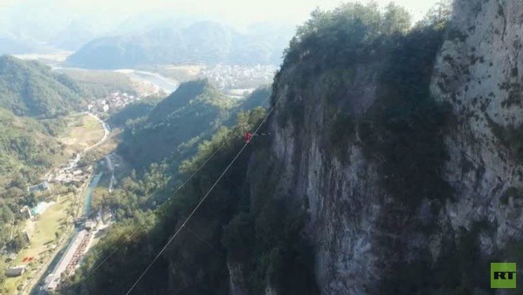 لقطات مذهلة لطائرة من دون طيار تصور رجلا يمشي على حبل عبر ممر ضيق (فيديو) 