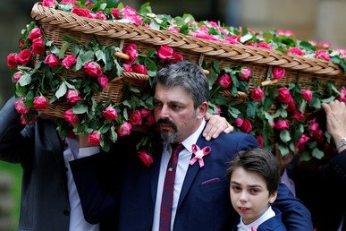 أندرو روز روسوس يضم ابنه بيد، ويحمل بالأخرى تابوت ابنته صافي روز روسوس، أصغر ضحية في هجوم ساحة مانشستر، في الجنازة المقامة بكاتدرائية مانشستر. 26 يوليو 2017