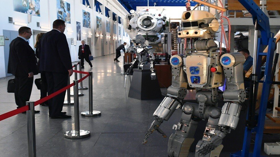 روبوت على هيئة إنسان  يستعد لقيادة  مركبة 