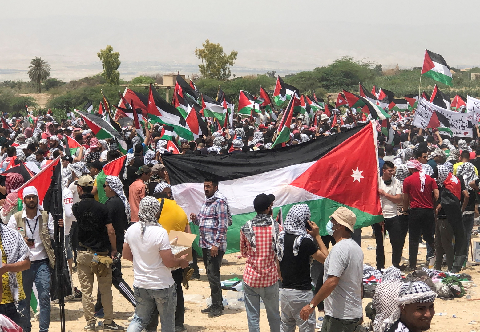 مواطنون يحملون الأعلام الأردنية والفلسطينية