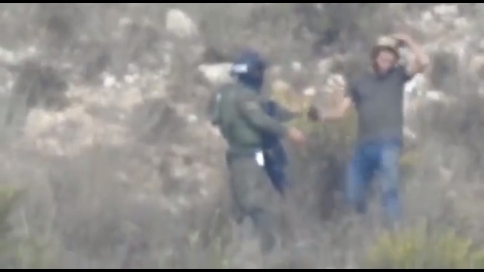 شاهد.. جندي إسرائيلي يرشد ويساعد مستوطنا في استعمال قنبلة غاز ضد الفلسطينيين