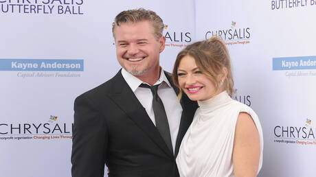 فنانة أمريكية تستمتع بتبادل القبلات مع ملياردير بينما زوجها القانوني يصارع المرض (صور)