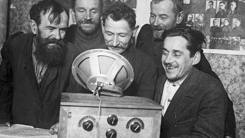 Farmers examine the first radio receiver on their collective farm.