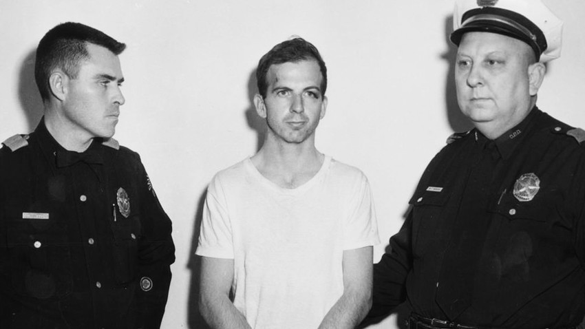 Lee Harvey Oswald, accused of assassinating former U.S. President John F. Kennedy, is pictured with Dallas police Sgt. Warren (R) and a fellow officer in Dallas.