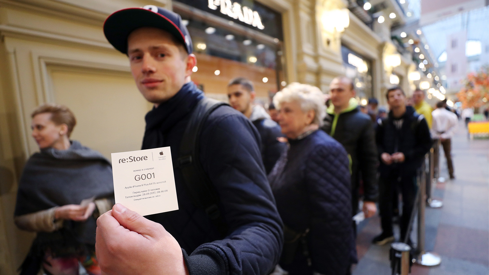 People wait in line inside the GUM department store to buy new iPhone 8 and iPhone 8 Plus as Apple's latest smartphones officially go on sale in Russia.