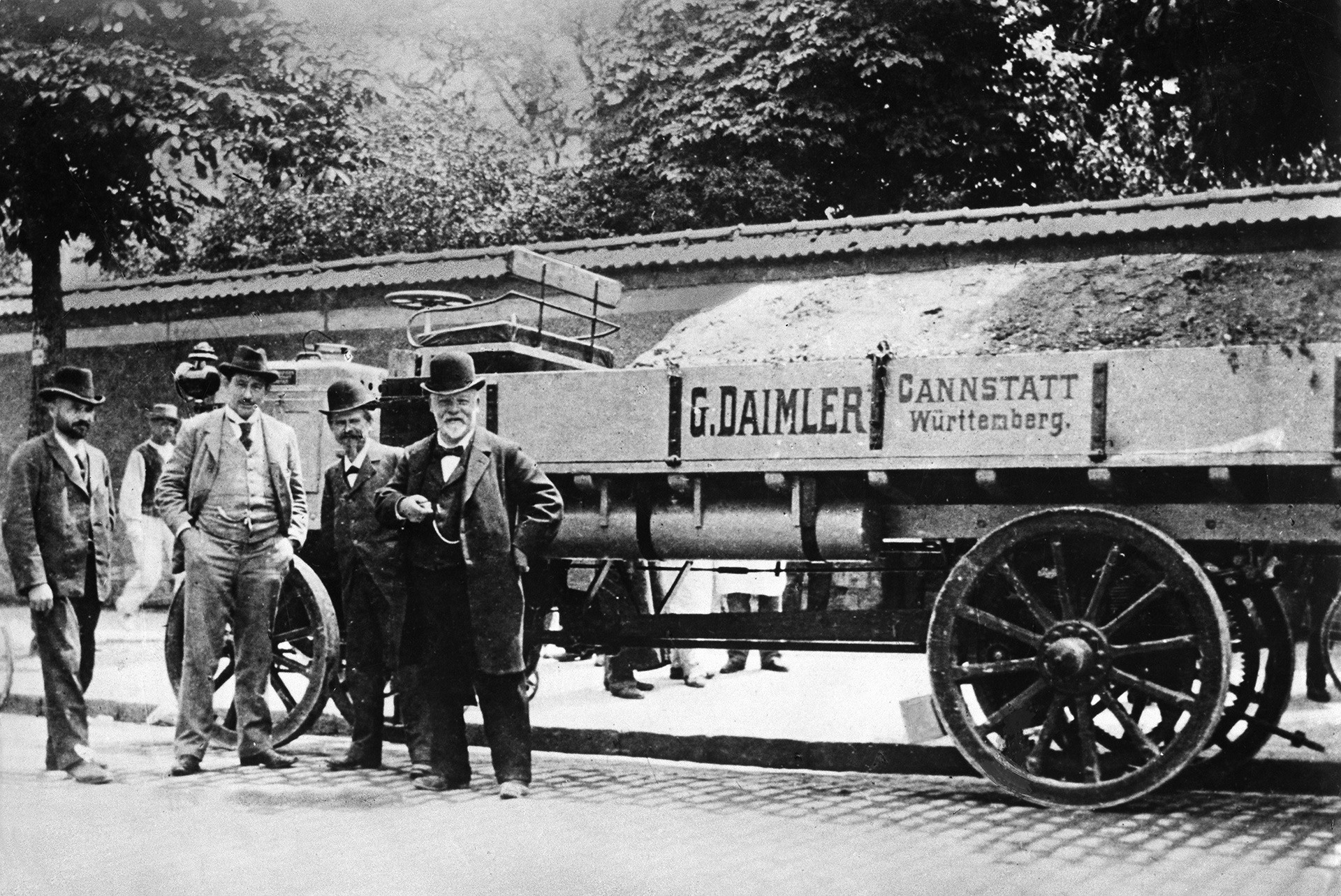 Gottlieb Daimler beside his motor truck during an exhibition in Paris, 1886.