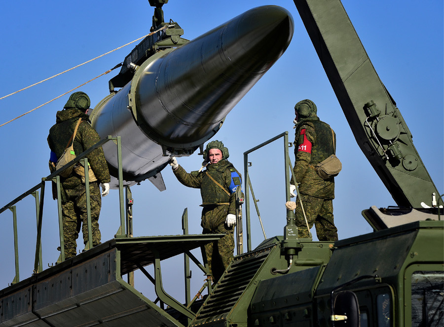 Loading a quasi ballistic missile into an Iskander-M missile launcher during a military exercise held by missile and artillery units of the Russian Eastern Military District's 5th army at a firing range in Ussuriysk. 
