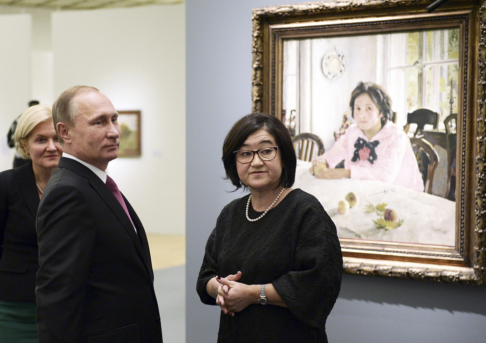 Vladimir Putin listens to director of the State Tretyakov Gallery Zelfira Tregulova as he visits an exhibition of artist Valentin Serov.