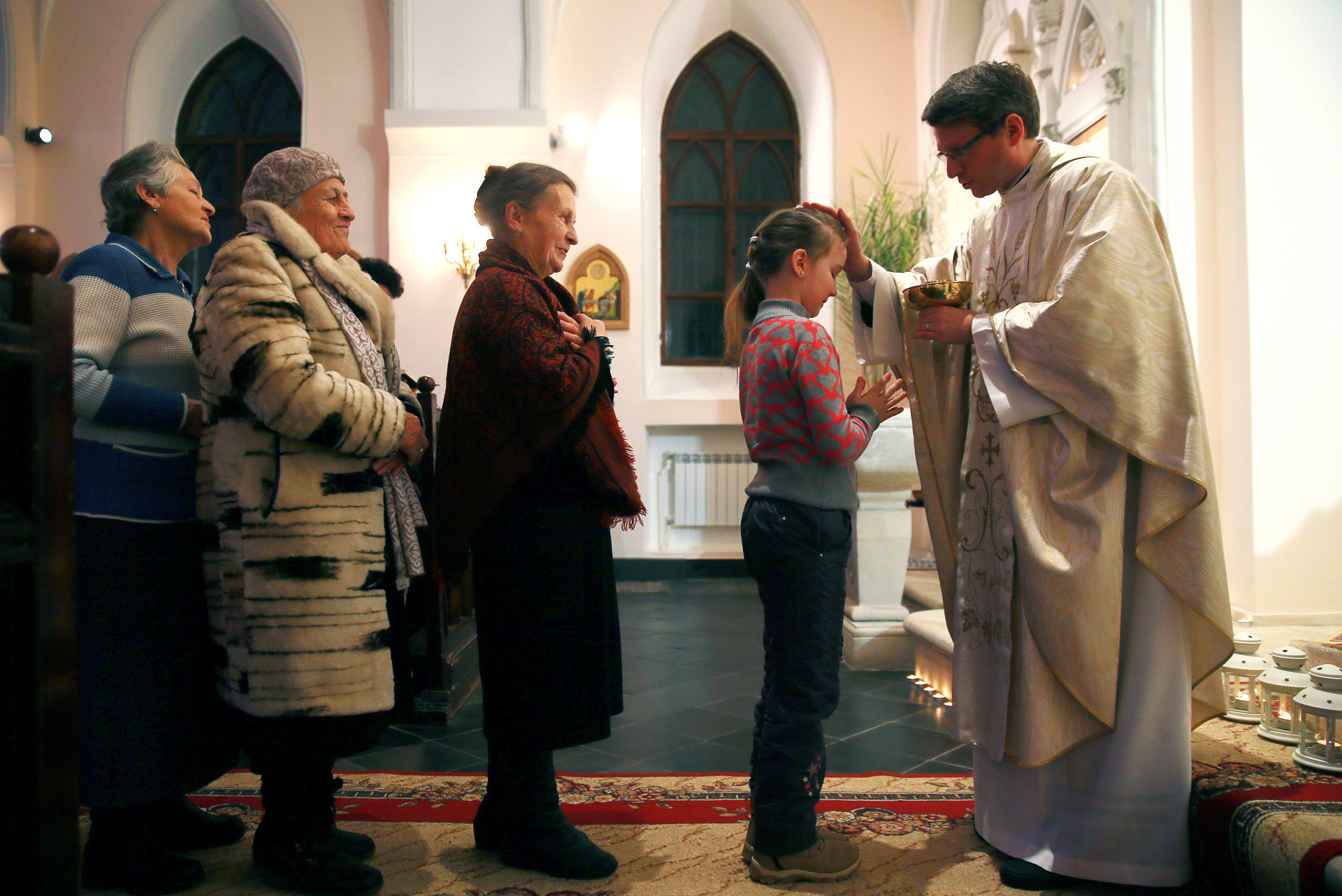 Un grupo de creyentes asiste a la tradicional misa de víspera de Navidad en la Iglesia de Nuestra Señora del Rosario en Vladímir.