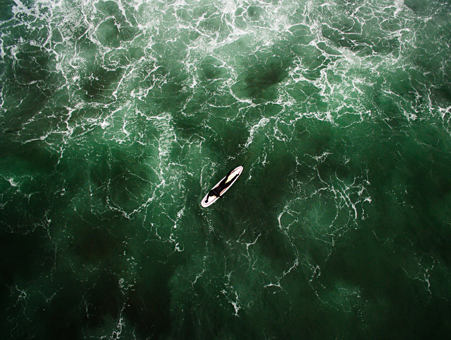 ロシア太平洋岸ウスリー湾のルースキー島沖の波に乗るサーファー