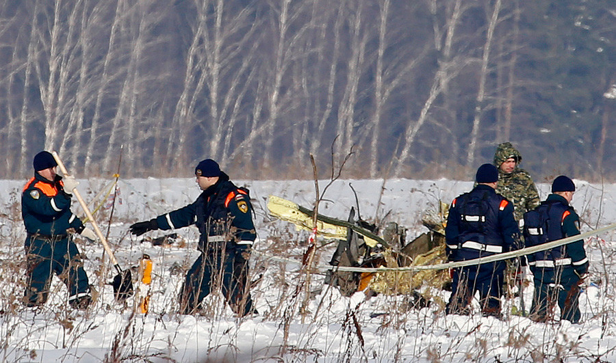 Personnel work at the scene of a AN-148 plane crash in Stepanovskoye village, about 40 kilometers (25 miles) from the Domodedovo airport, Russia.