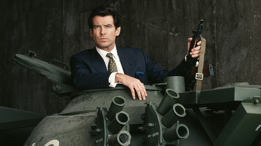 Irish actor Pierce Brosnan poses in the hatch of a Russian T55 Main Battle Tank holding a Kalashnikov automatic rifle, in a publicity still for the James Bond film 'GoldenEye', 1995