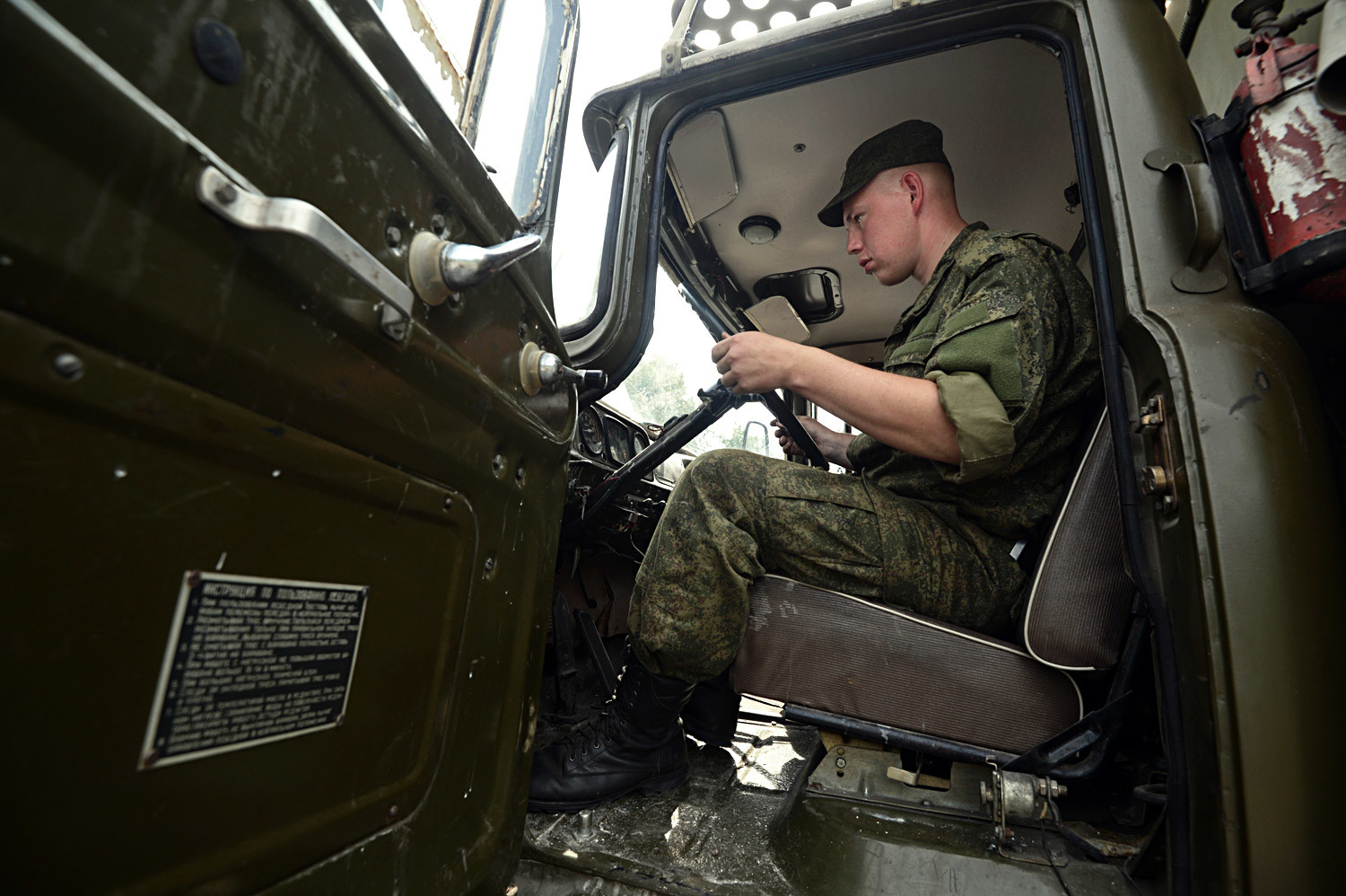 The driver of a truck at a military equipment storage, maintenance and repair facility in Novosibirsk. This facility will host a camp assembly of army reservists