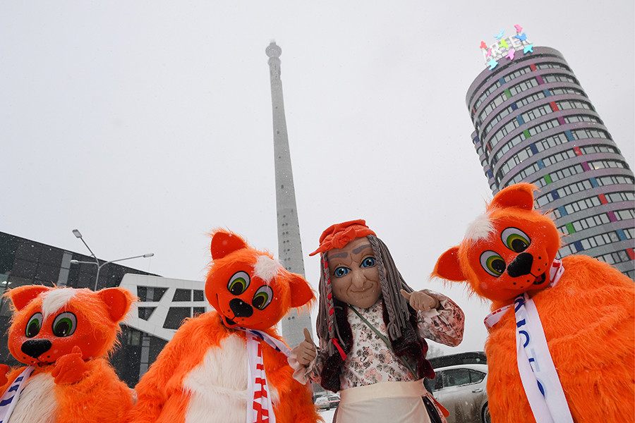 People wearing costumes take part in a rally titled 'Let's Hug Our Tower' against the demolition of an abandoned TV tower.