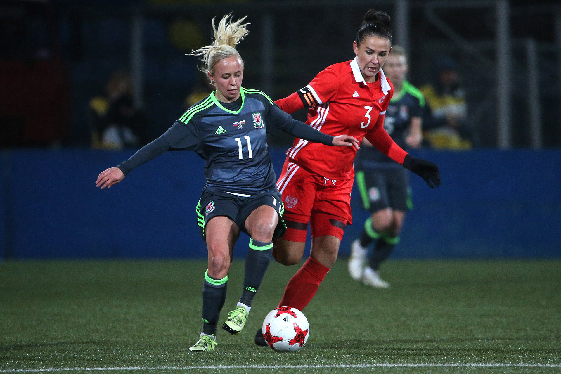 Wales' Nadia Lawrence (L) and Russia's Anna Kozhnikova in the 2019 FIFA Women's World Cup Qualification football match between Russia and Wales.