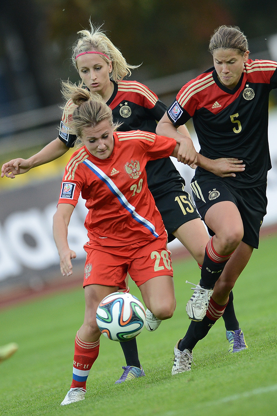 Nelli Korovkina (Russia), Kathrin Hendrich (Germany) and Annike Krahn (Germany), from left, during the Football World Cup 2015 qualification match between the national women's teams of Russia and Germany.