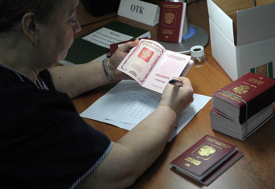 Employee of FSUE Goznak checks the quality of finished biometric passports for Russian citizens in the Reserve personalization Center at FSUE 