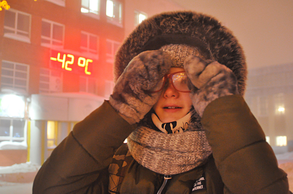 A girl is seen in a street at -42 degrees Celsius, Norilsk.