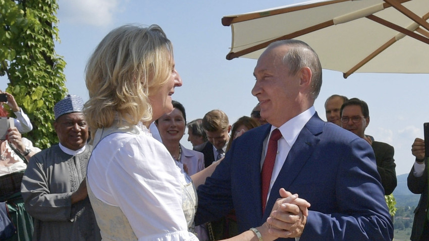 Vladimir Putin dances with Austrian Foreign Minister Karin Kneissl