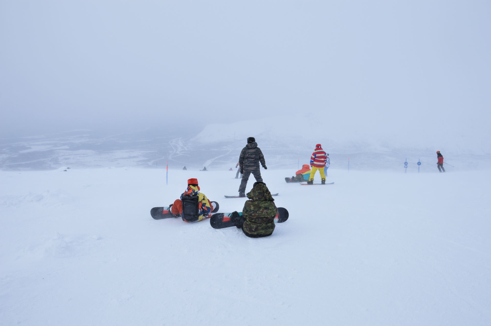 Braving the elements on top of a mountain.