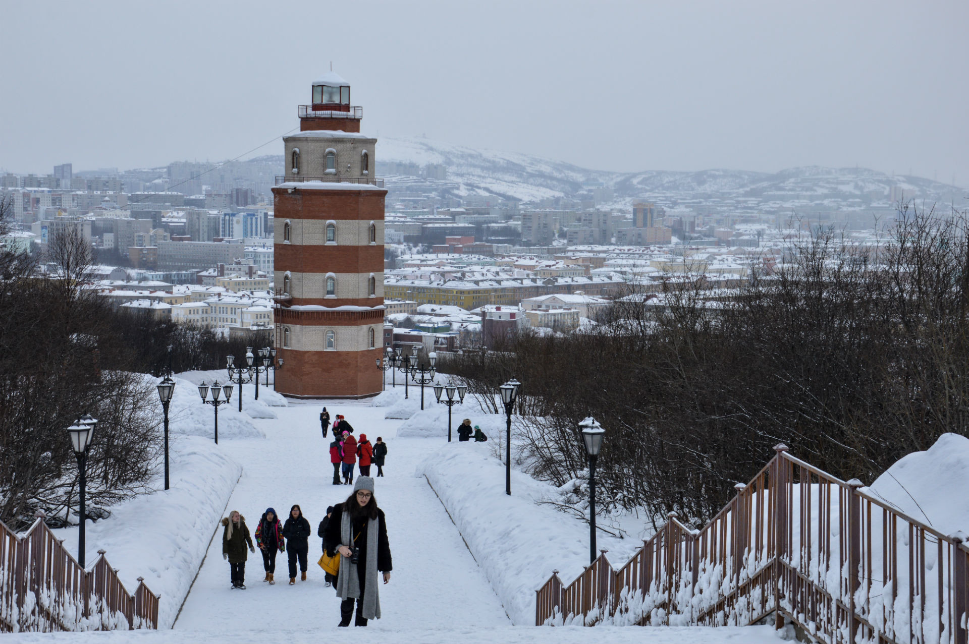 The lighthouse looms over the city and sea. Fishing and shipbuilding industries are important in this region.  