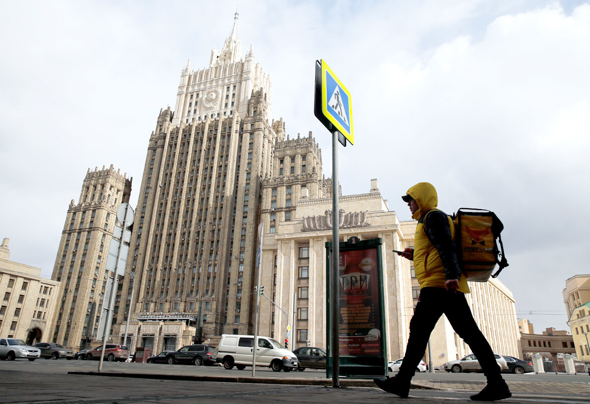 A food delivery service courier walks in front of the Russian Foreign Ministry headquarters in Moscow