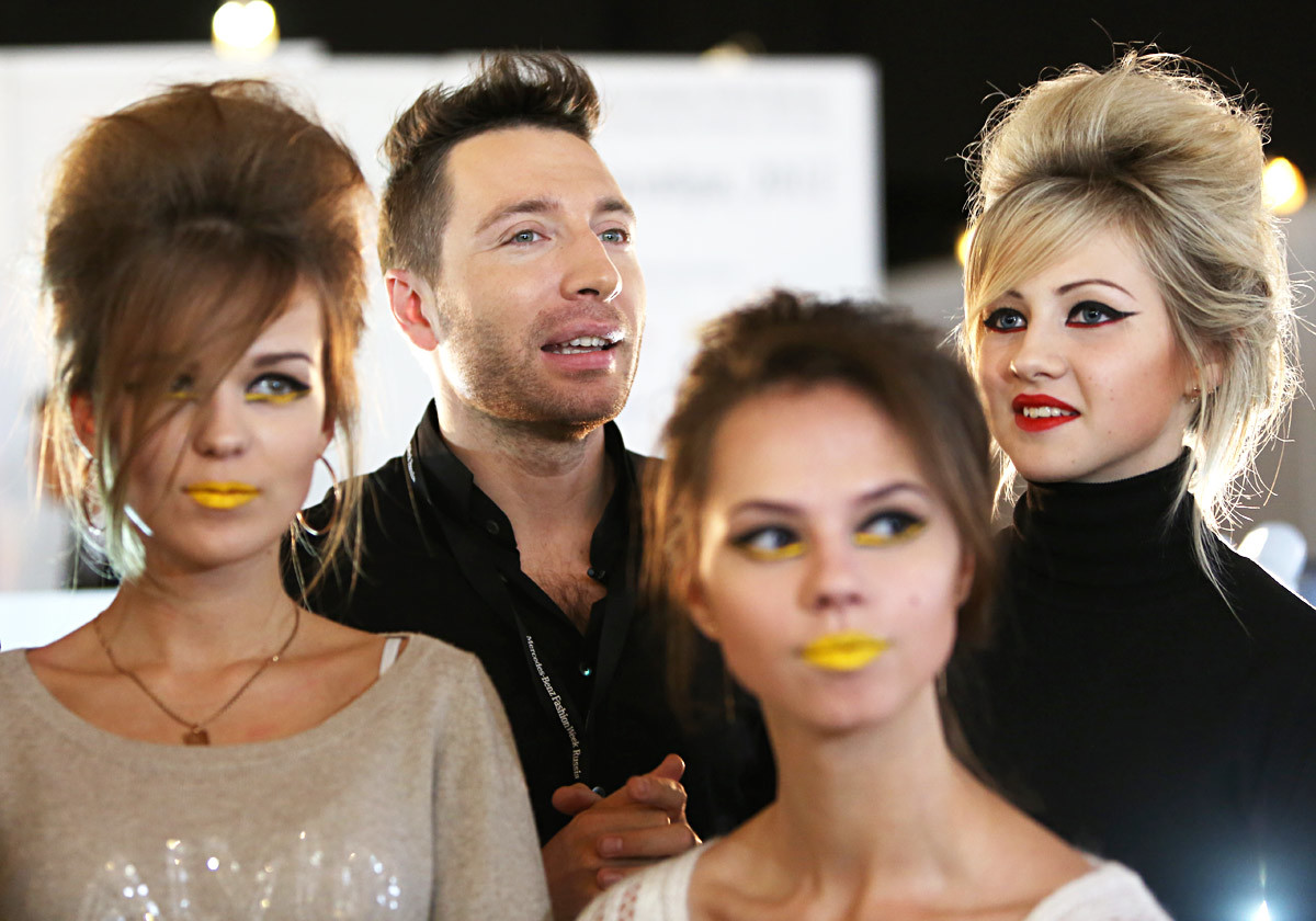 Yury Stolyarov with models during the showings in Mercedes-Benz Fashion Week Russia. 
