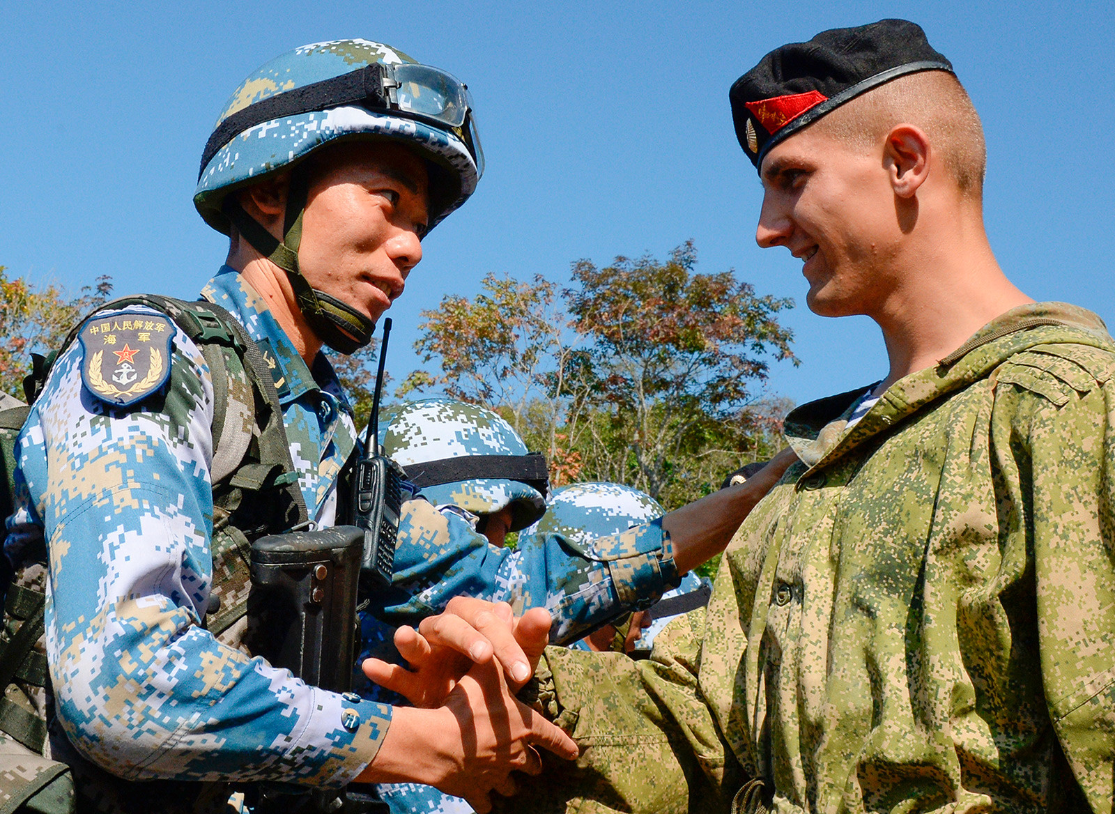 Russian and Chinese marines shaking hands during a joint military drill, 2017.