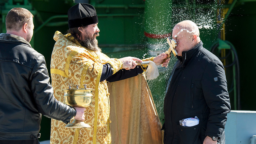 Orthodox Priest blesses Sergey Semchenko of the Russian Search and Recovery Forces after having blessed the Soyuz rocket at the Baikonur Cosmodrome Launch