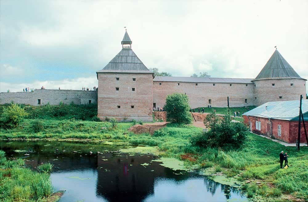 Fortaleza de Stáraia Ládoga. Muro oeste con la Torre de Vorótnaia (izquierda) y la Torre de Clemente. En primer plano: río Ládozhka. 16 de agosto de 2003