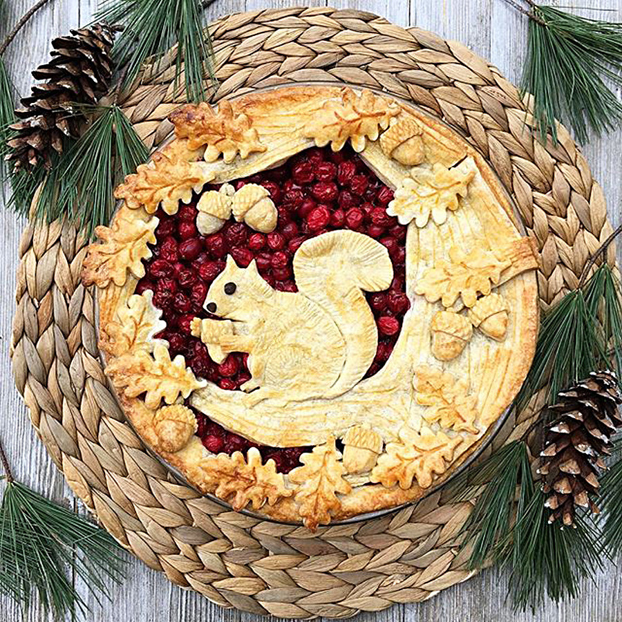 Cranberry pie with a squirrel and acorns.