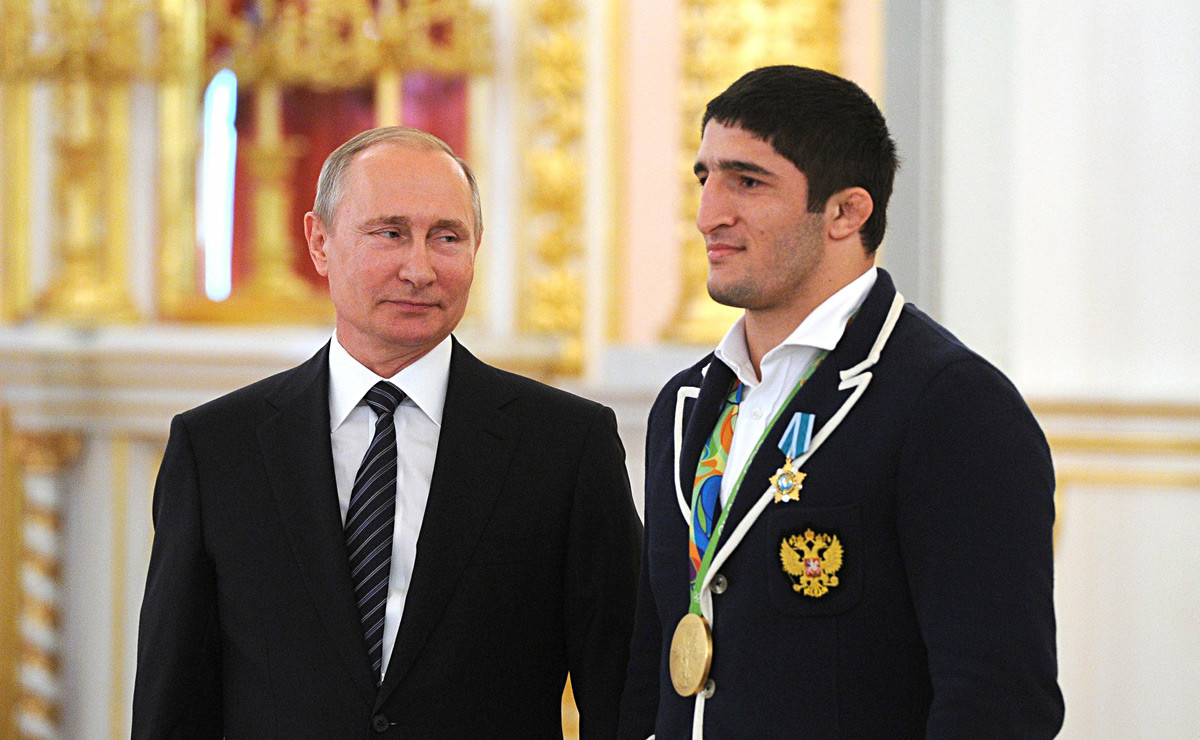 Russian President Vladimir Putin (left) and Rio 2016 Olympic champion in freestyle wrestling Abdulrashid Sadulaev at the ceremony to present state awards to medalists of the 2016 Summer Olympics in Rio de Janeiro