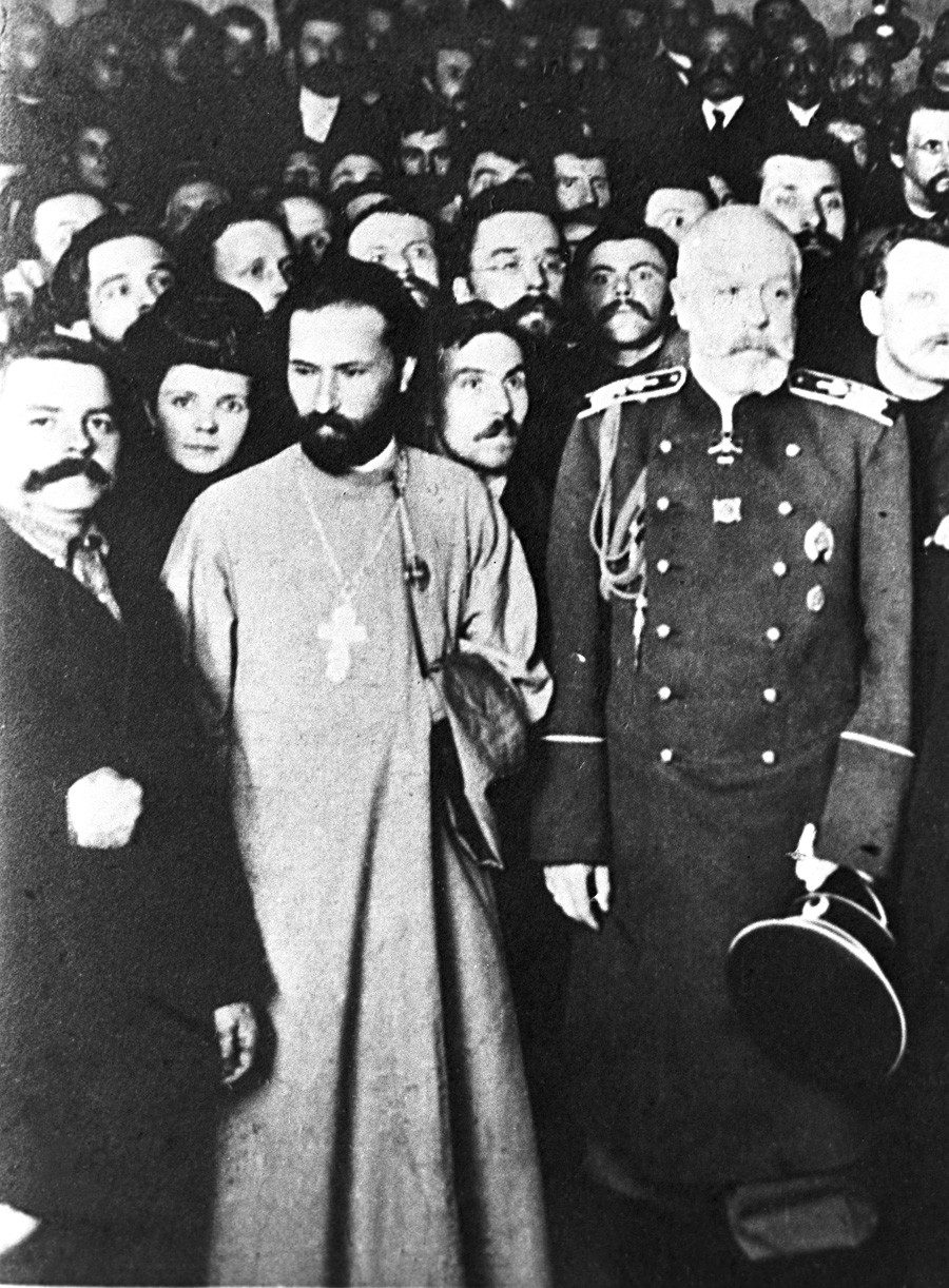 Georgi Gapon (2.v.l.) und der St. Petersburger Bürgermeister Iwan Fullon (3.v.l.) auf einem Treffen der Vereinigung der russischen Fabrik- und Mühlenarbeiter