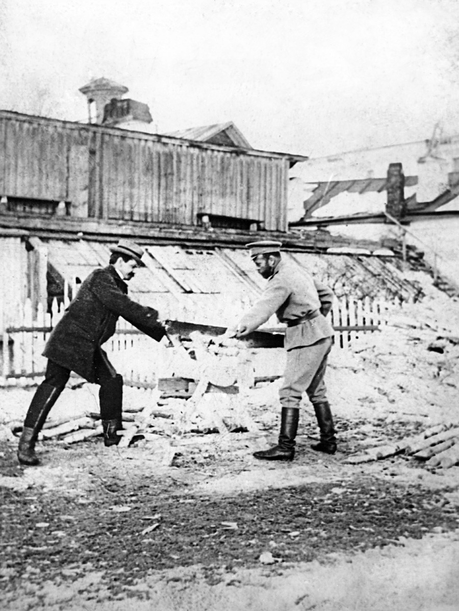Tsar Nicholas ll cutting wood with Pierre Gilliard in Tobolsk, 1918.